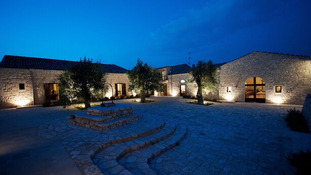 A stone building with a courtyard, steps leading to a door, and trees. - La Dimora di Spartivento, BW Signature Collection (Ragusa)