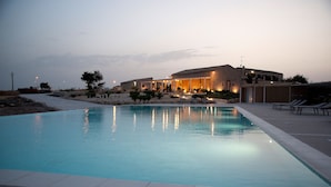 A swimming pool with a stone building in the background. - La Dimora di Spartivento, BW Signature Collection (Ragusa)