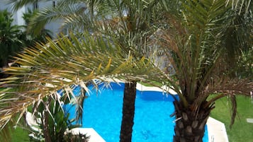 Surrounded by lush greenery, this pool area offers a tranquil escape.