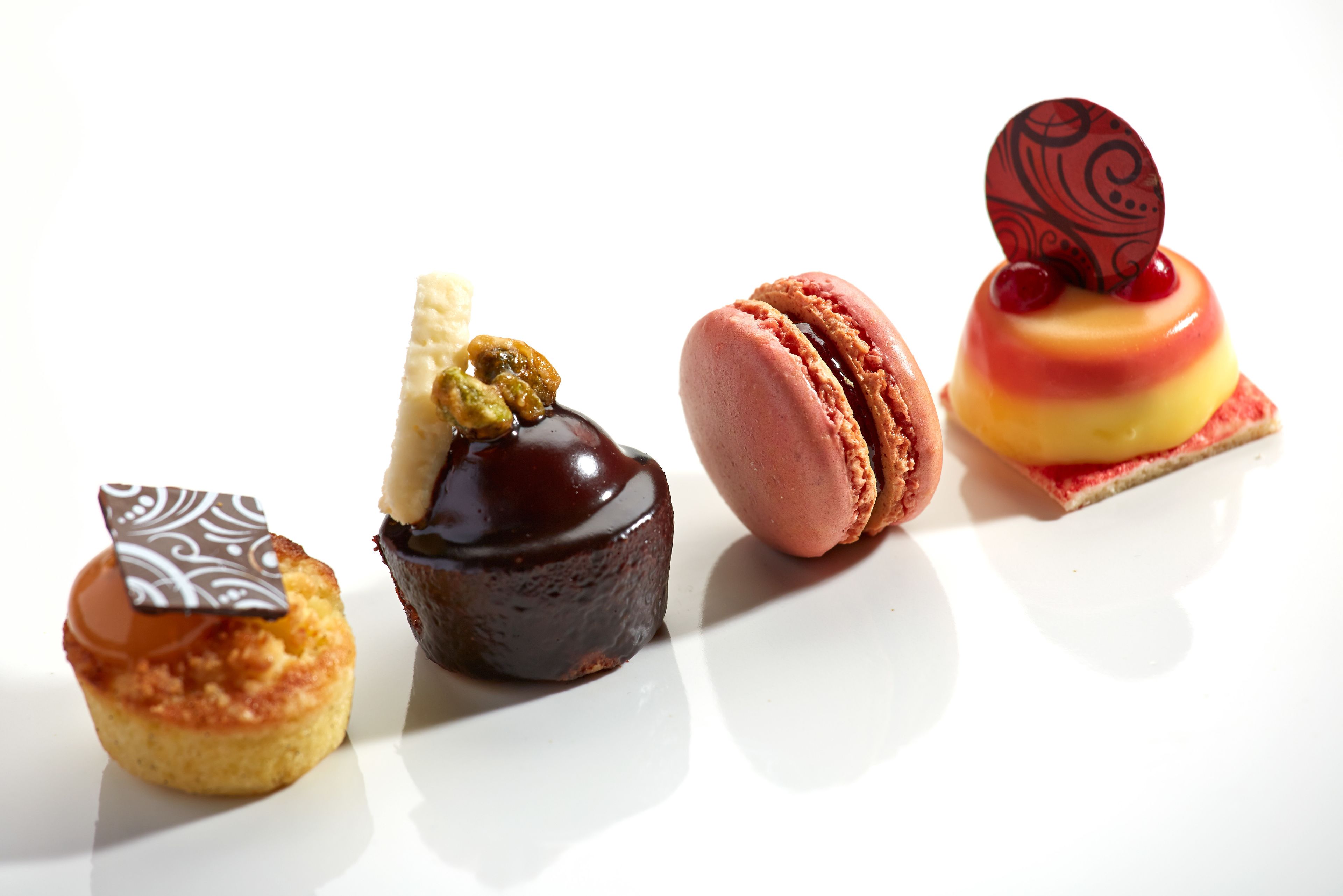 Four desserts on a white plate.