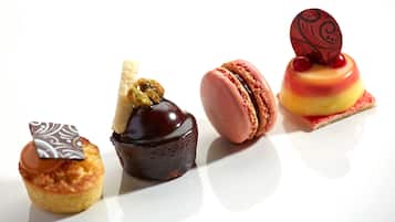 Four desserts on a white plate.