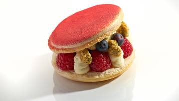 A dessert with a red topping and various berries.