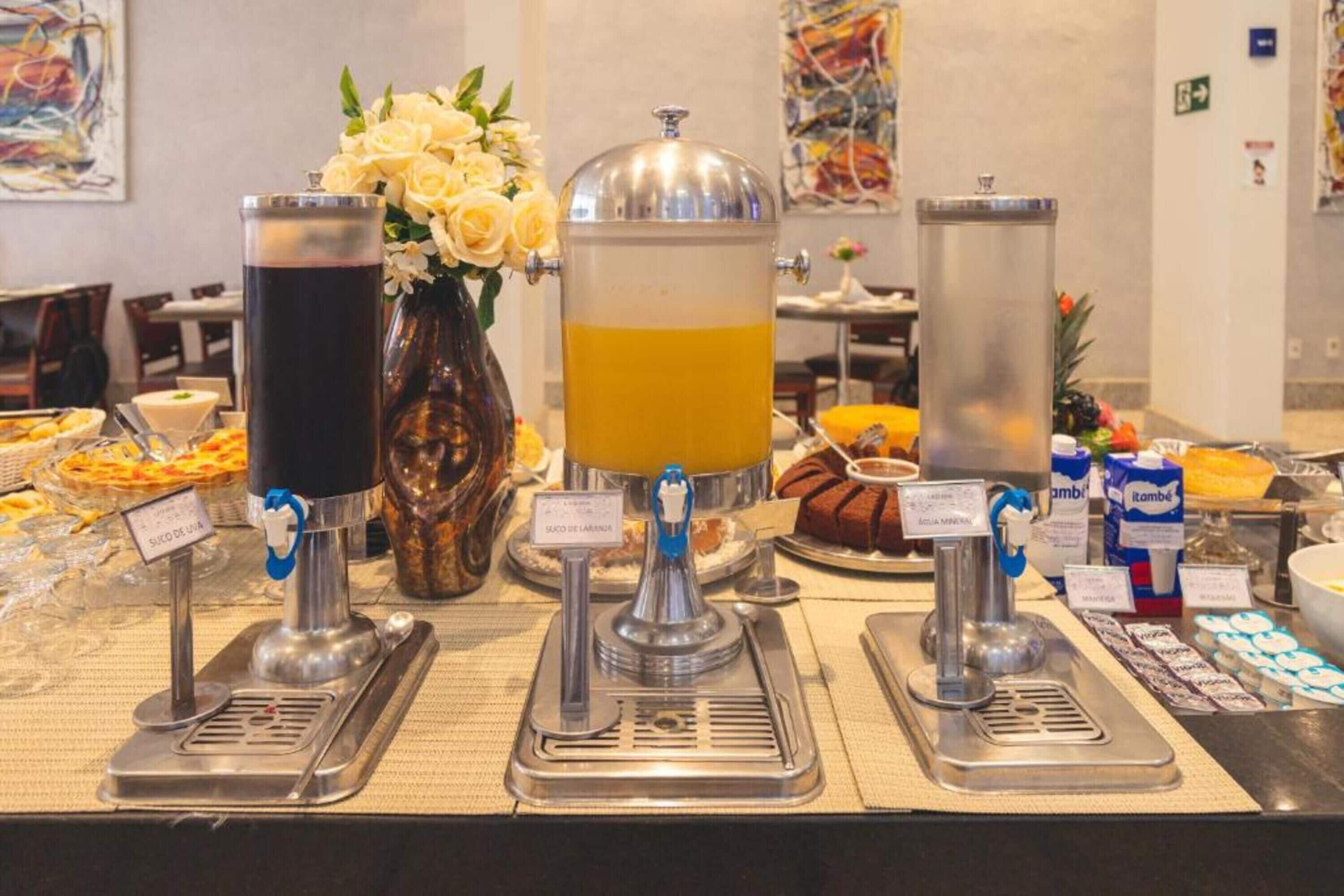 A buffet setup with various food items and beverage dispensers.