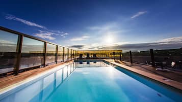 Outdoor pool, open 8 AM to 10 PM, pool loungers