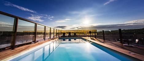 Outdoor pool, open 8 AM to 10 PM, pool loungers