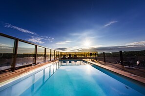 Outdoor pool, open 8 AM to 10 PM, pool loungers