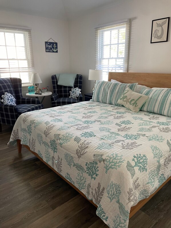 A bedroom with a bed, two chairs, a small table, and a window. - The Tern Inn Bed & Breakfast and Cottages (West Harwich)