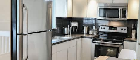 Studio, 1 Queen Bed | Private kitchen | Full-sized fridge, microwave, stovetop, coffee/tea maker