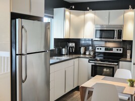 Studio, 1 Queen Bed | Private kitchen | Full-size fridge, microwave, stovetop, coffee/tea maker