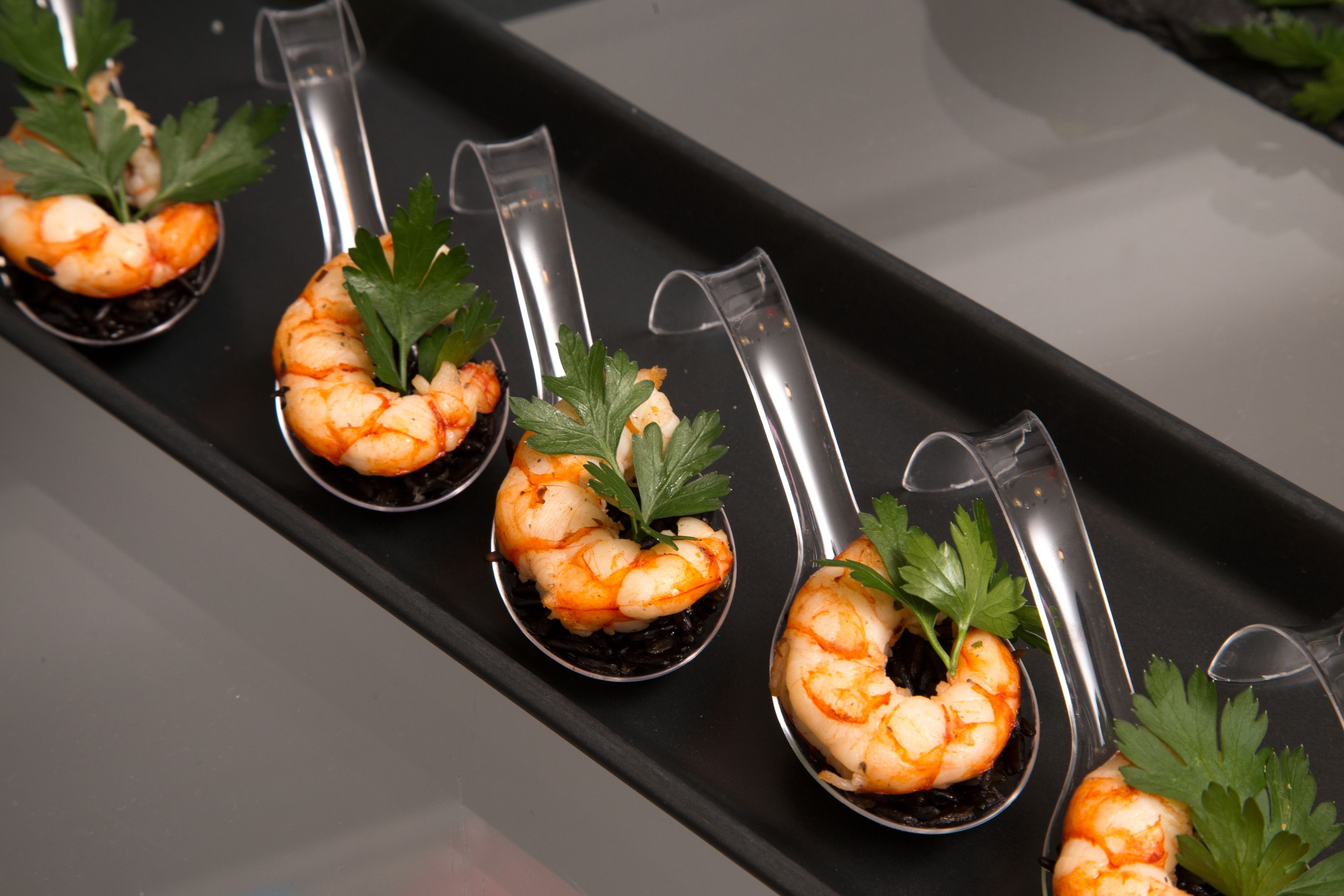 A tray with shrimp appetizers garnished with parsley.