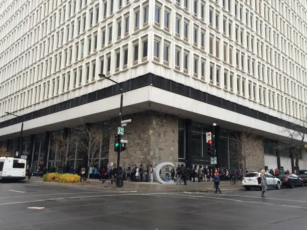 A modern building with a large glass facade and a prominent entrance.