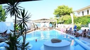 A pool area with lounge chairs and a covered seating area. - Cavo D'Oro Apartments (Corfu)