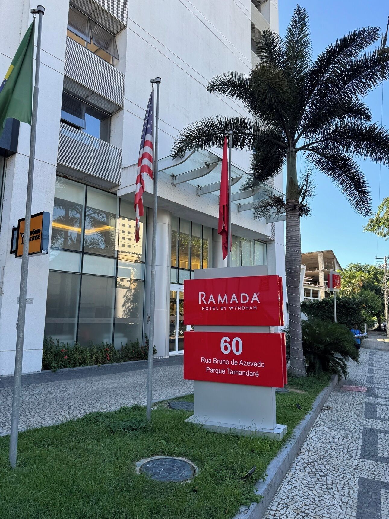 A modern building with a sign for Ramada Hotel by Wyndham, indicating room number 60.