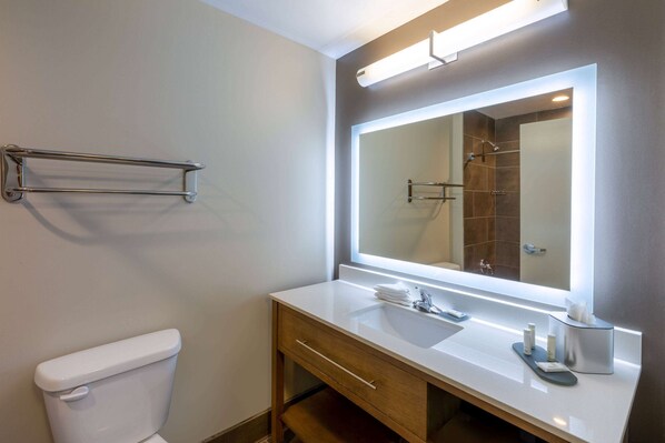 A modern bathroom with a white sink, a large mirror, and a towel rack. - La Quinta Inn & Suites by Wyndham Tulsa Downtown/Route 66 (Tulsa)