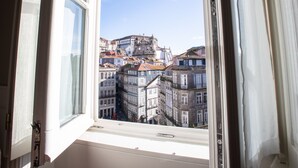 An open window with a view of a cityscape, including buildings and a clear sky. - Porto A.S. 1829 Hotel (Porto)