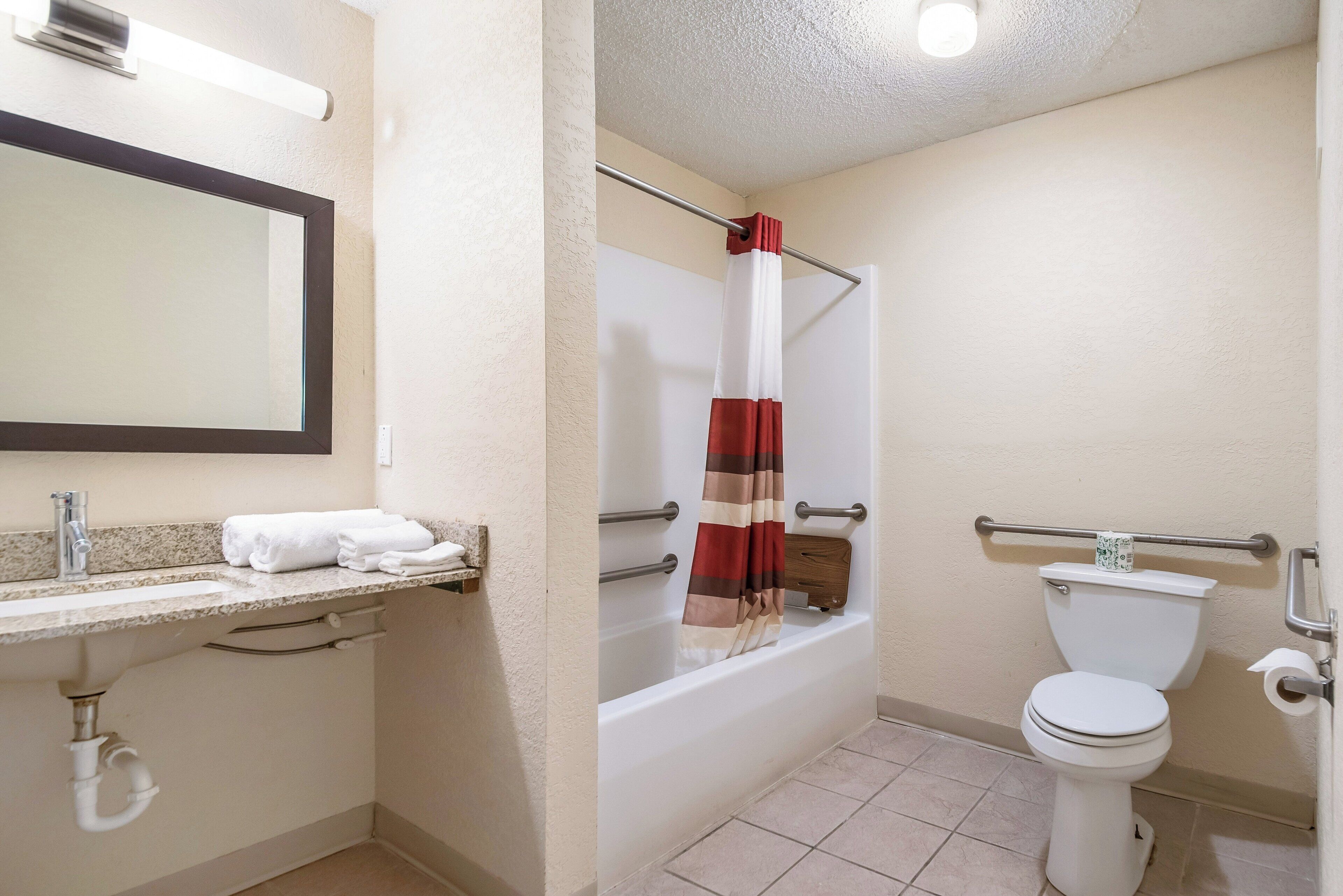 A bathroom with a bathtub, toilet, and sink.