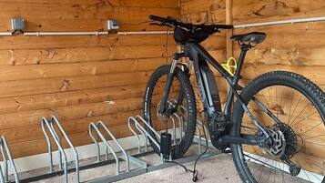 A wooden interior with a bike rack holding two bicycles.