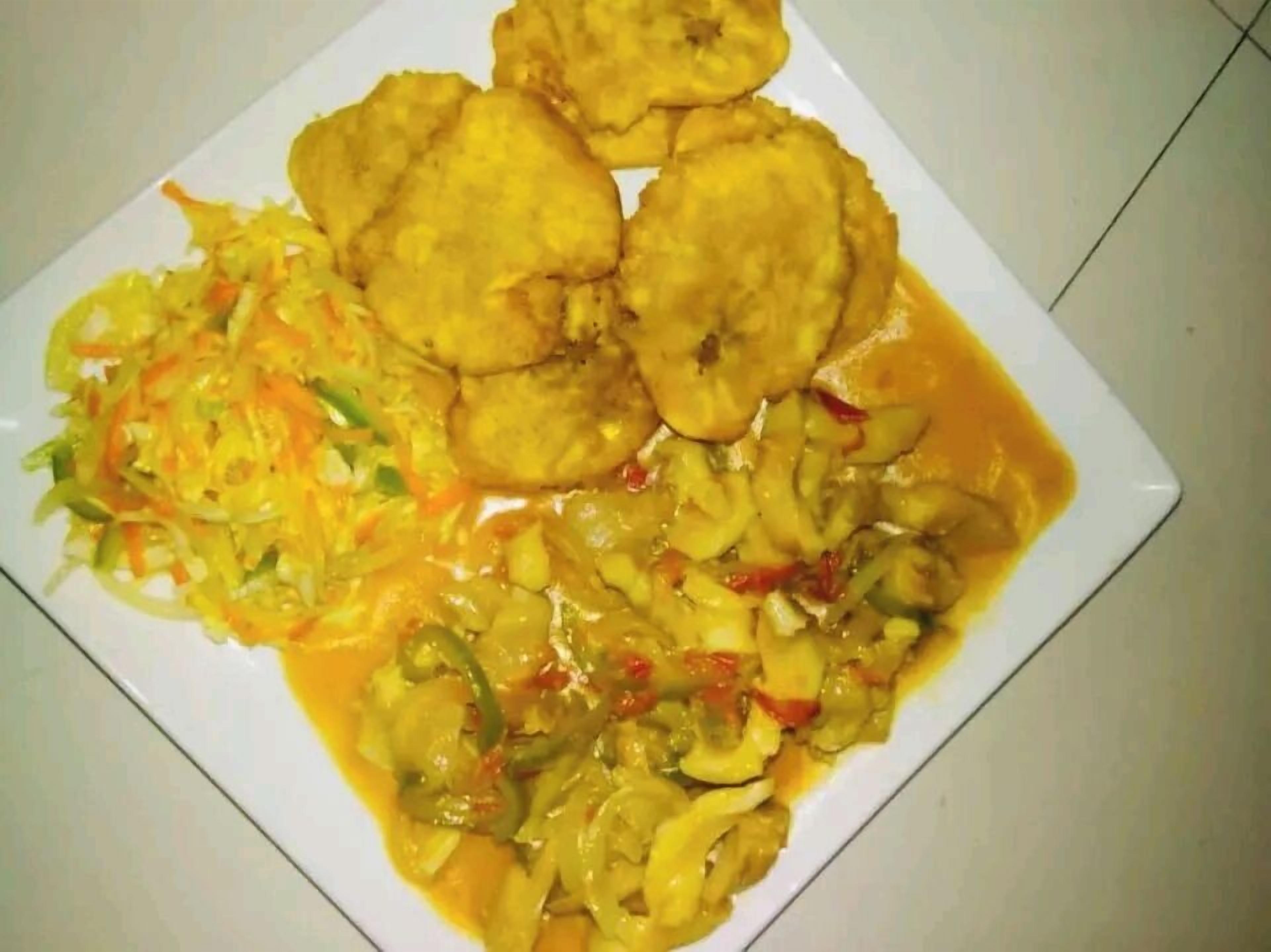 A plate of food with fried items and a vegetable dish.