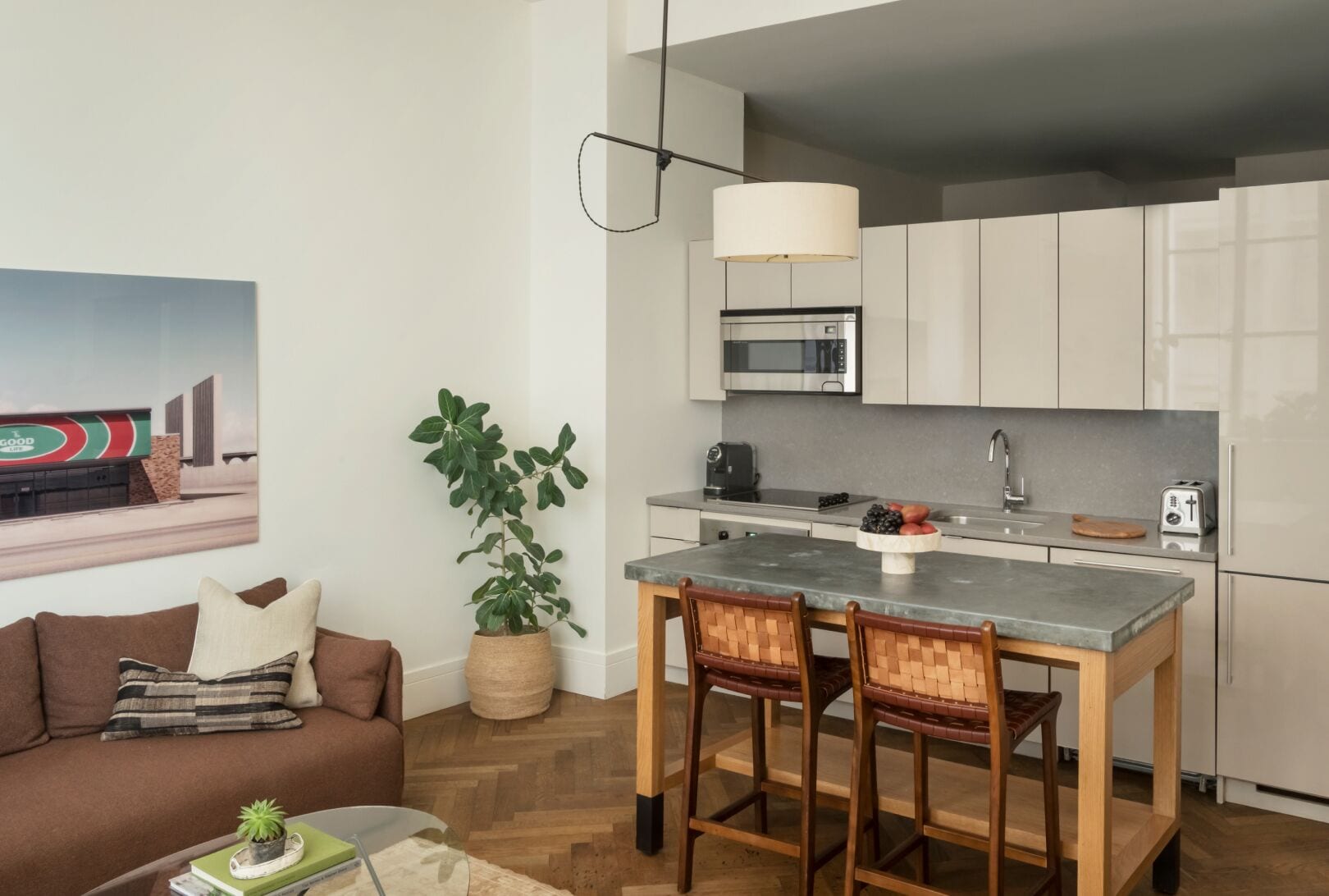 A modern kitchen with a microwave, toaster, and a dining area with a table and chairs.