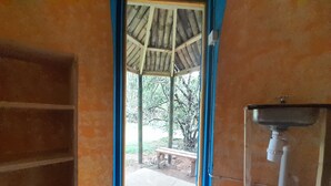 A room with a wooden bench outside, a sink, and a tiled floor. - 3 Rivers & Rosalie Forest Eco Lodge (Rosalie)