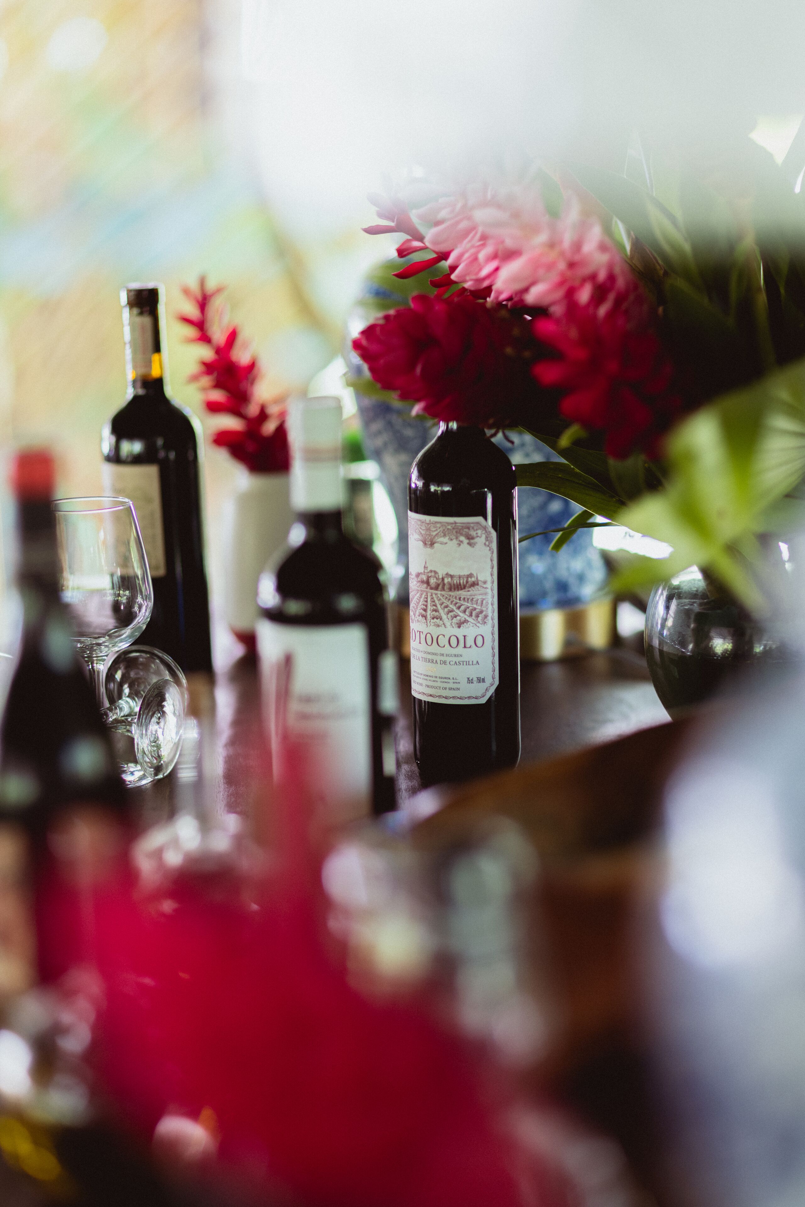 A bar area with bottles of wine and a glass.