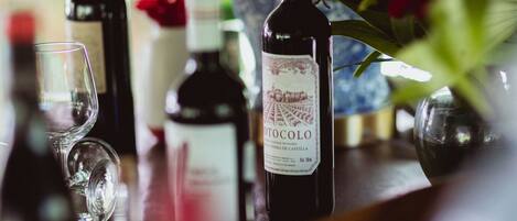A bar area with bottles of wine and a glass.