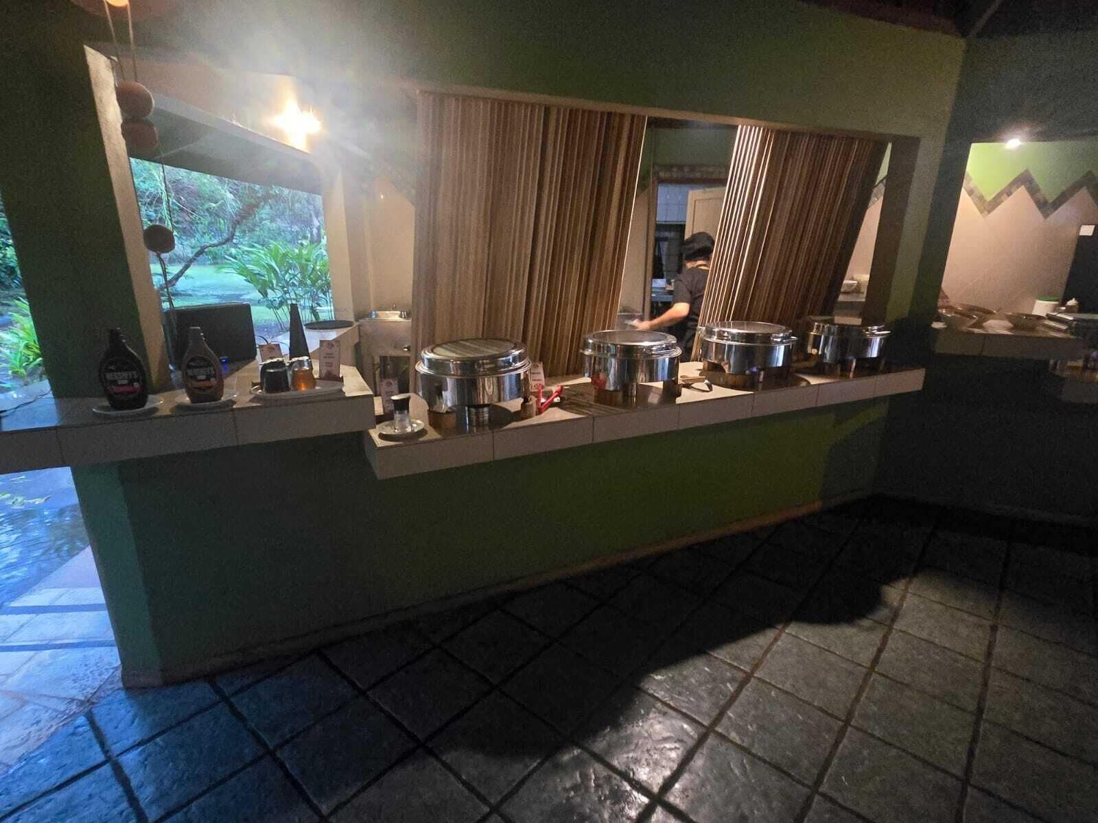 A buffet setup with various food containers and condiments.