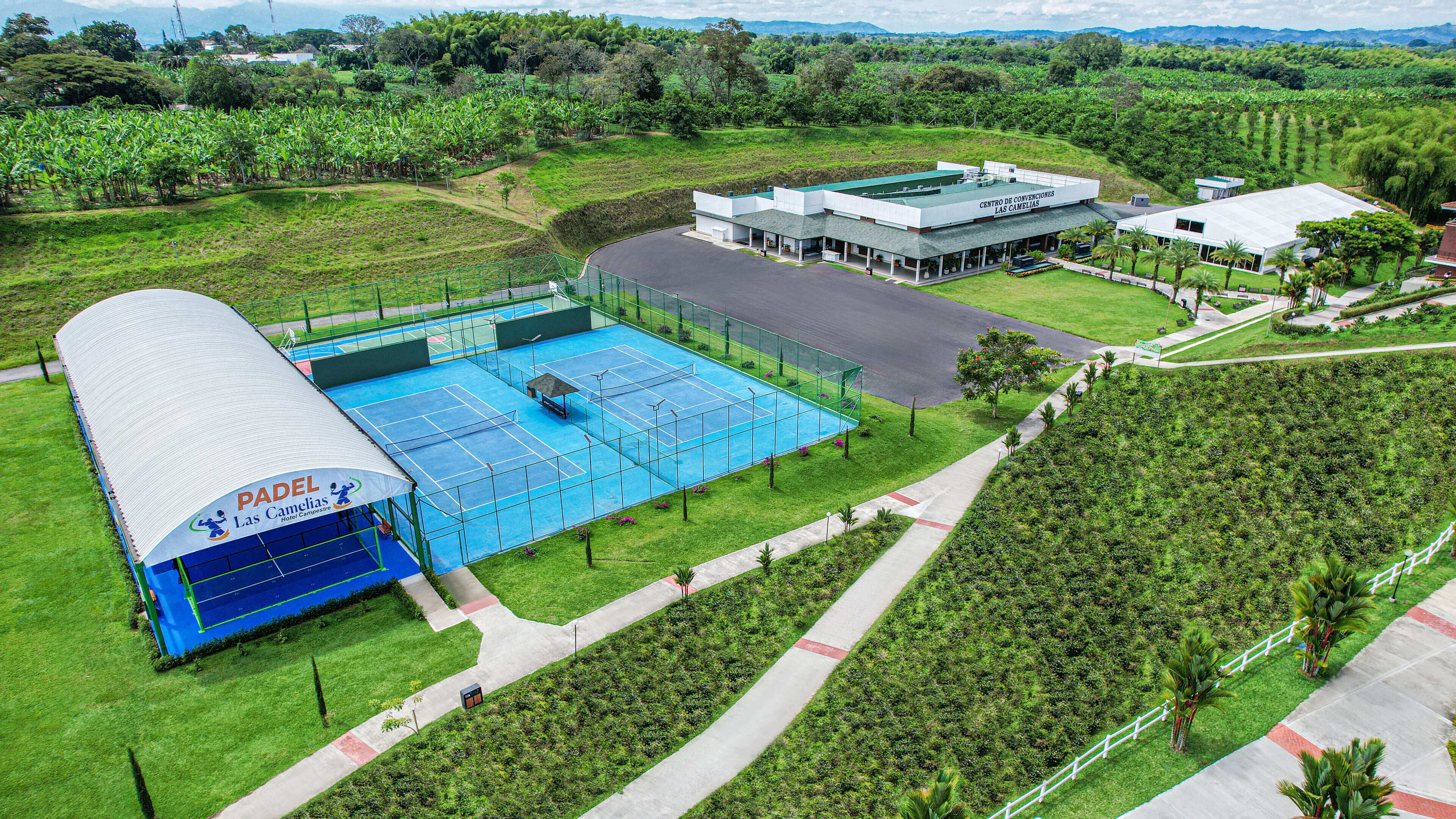 A tennis court with a pavilion labeled "Padel Las Camelias."