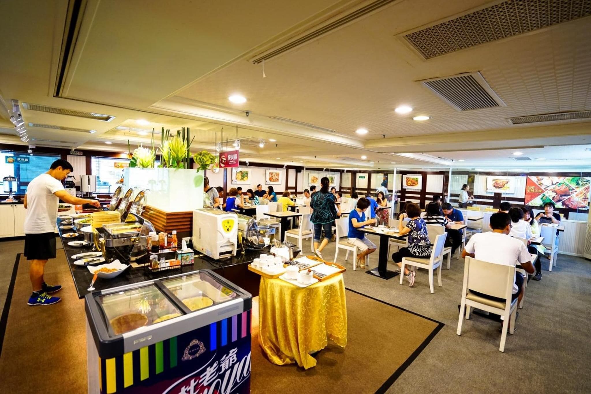 A buffet-style restaurant with multiple food stations and tables.