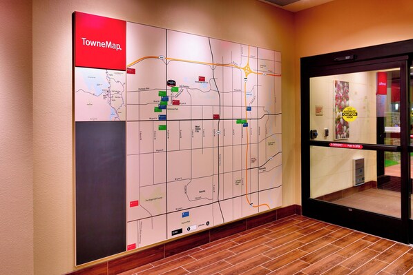 A wall map with various colored markers indicating locations.