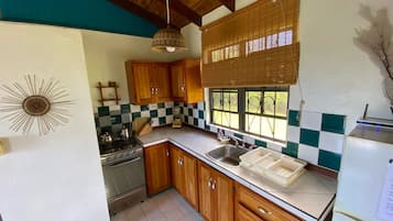 Cottage, Balcony, Ocean View | Private kitchen | Full-size fridge, oven, stovetop, coffee/tea maker