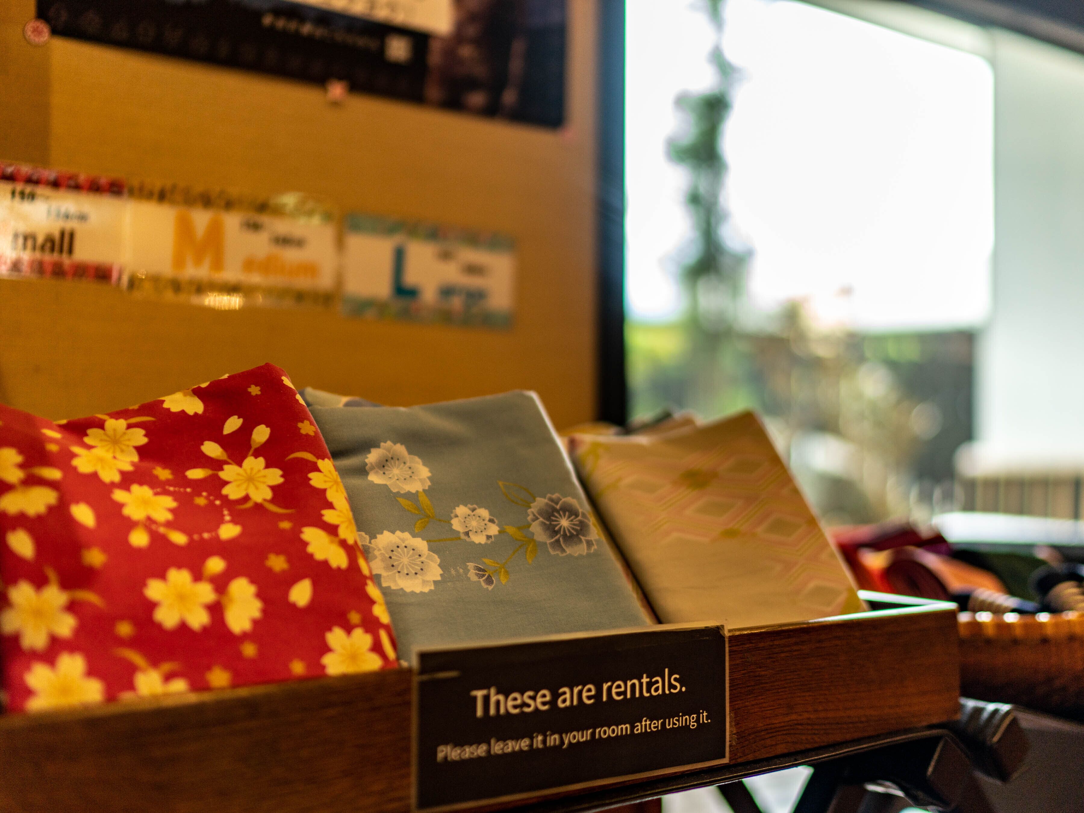 A display of rental items with a sign stating "These are rentals. Please leave it in your room after using it."