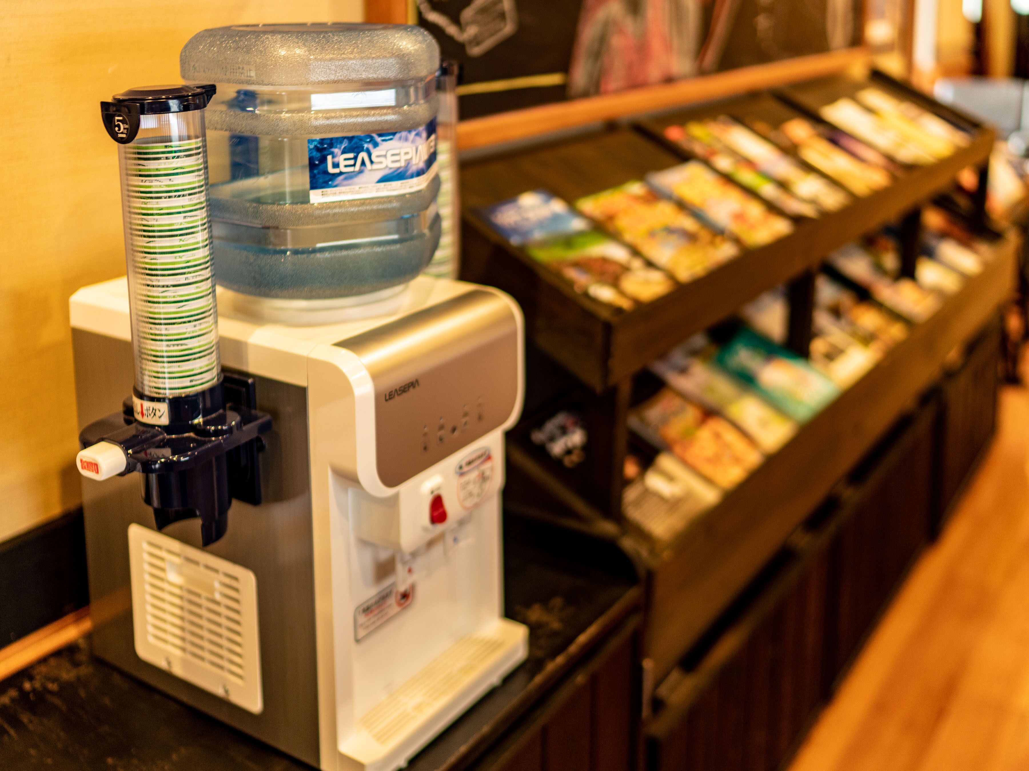 A water dispenser with a large water bottle and a control panel.