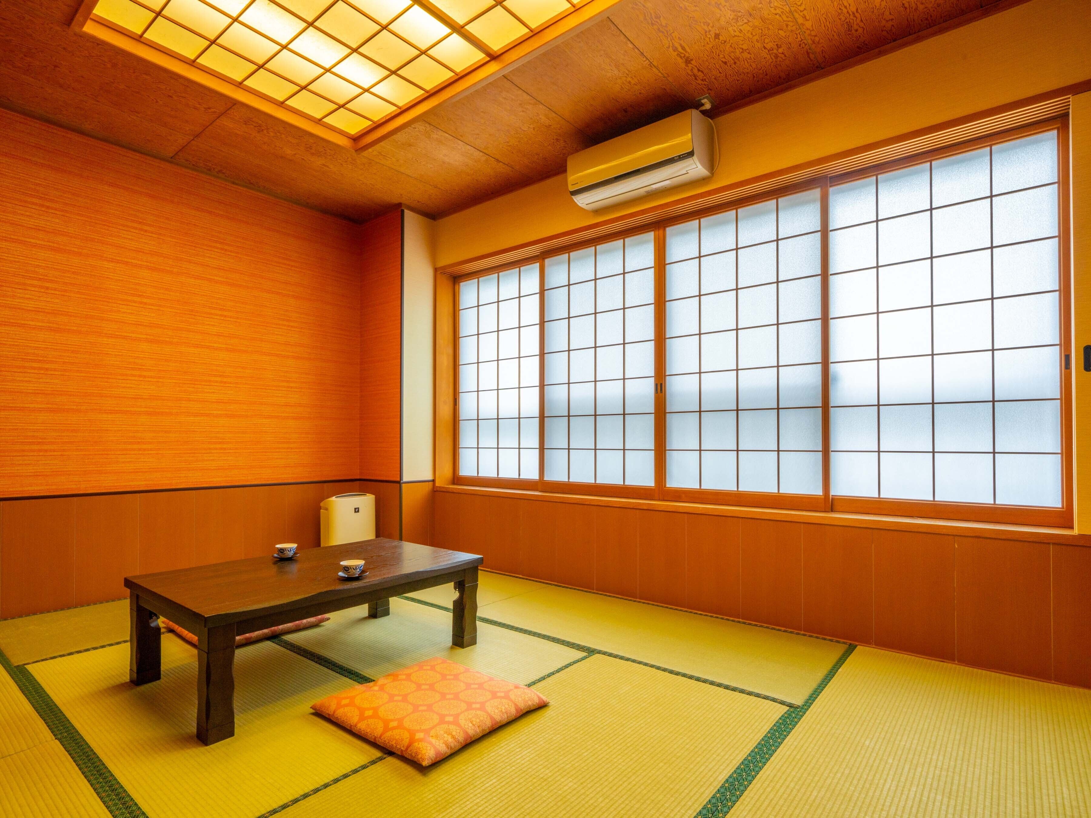 A traditional Japanese room with tatami flooring, a low wooden table, and a sliding shoji screen door.