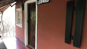 A red building with a door labeled "LEOPARD" and a window. - Maasai Simba Camp (Amboseli)