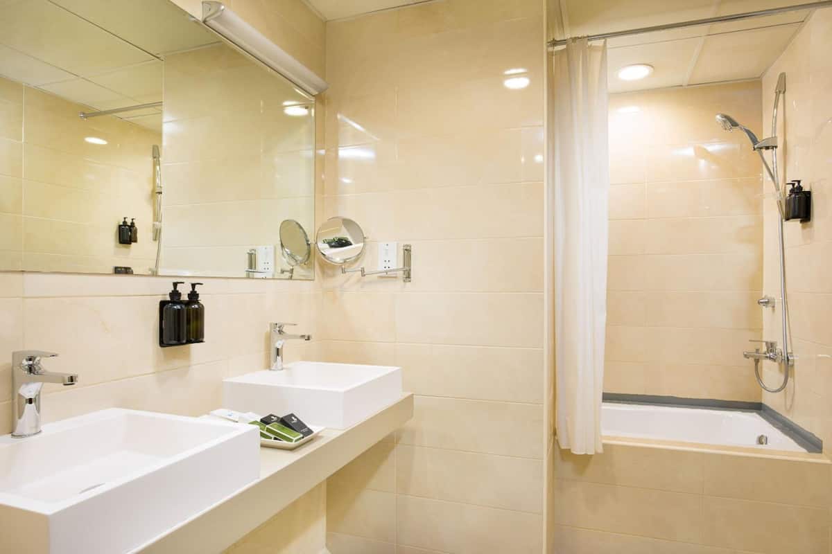 shower, hair dryer, slippers, towels