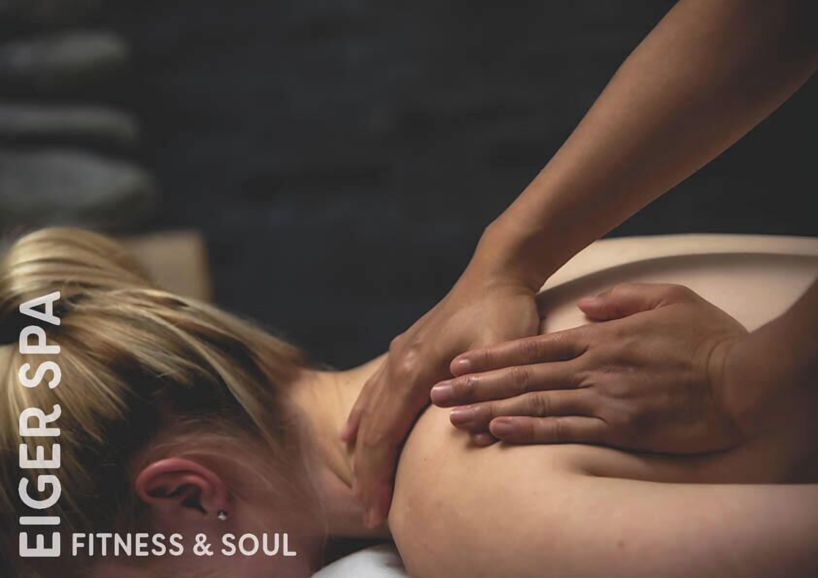 A person receiving a back massage at a spa.