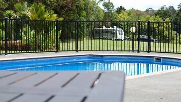 Seasonal outdoor pool, open 10:00 AM to 8:00 PM, pool umbrellas