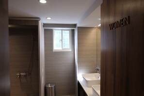 A modern bathroom with a shower, a sink, and a vanity.
