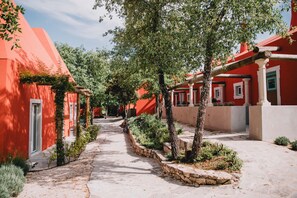 Stroll through the tranquil courtyard, surrounded by traditional buildings with white-framed windows and doors.