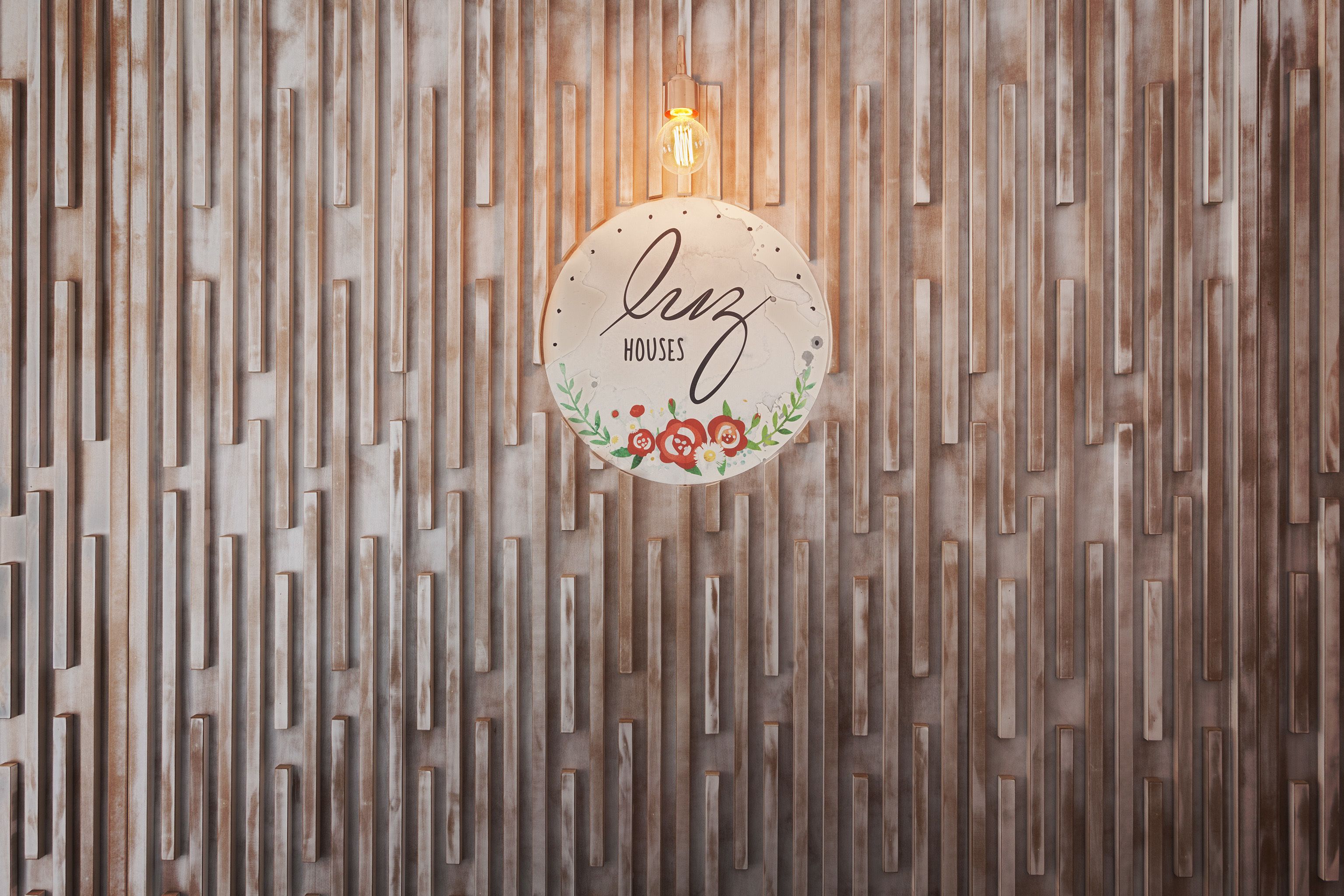 A wall with vertical wooden slats and a circular sign with the text "Houses" and decorative elements.