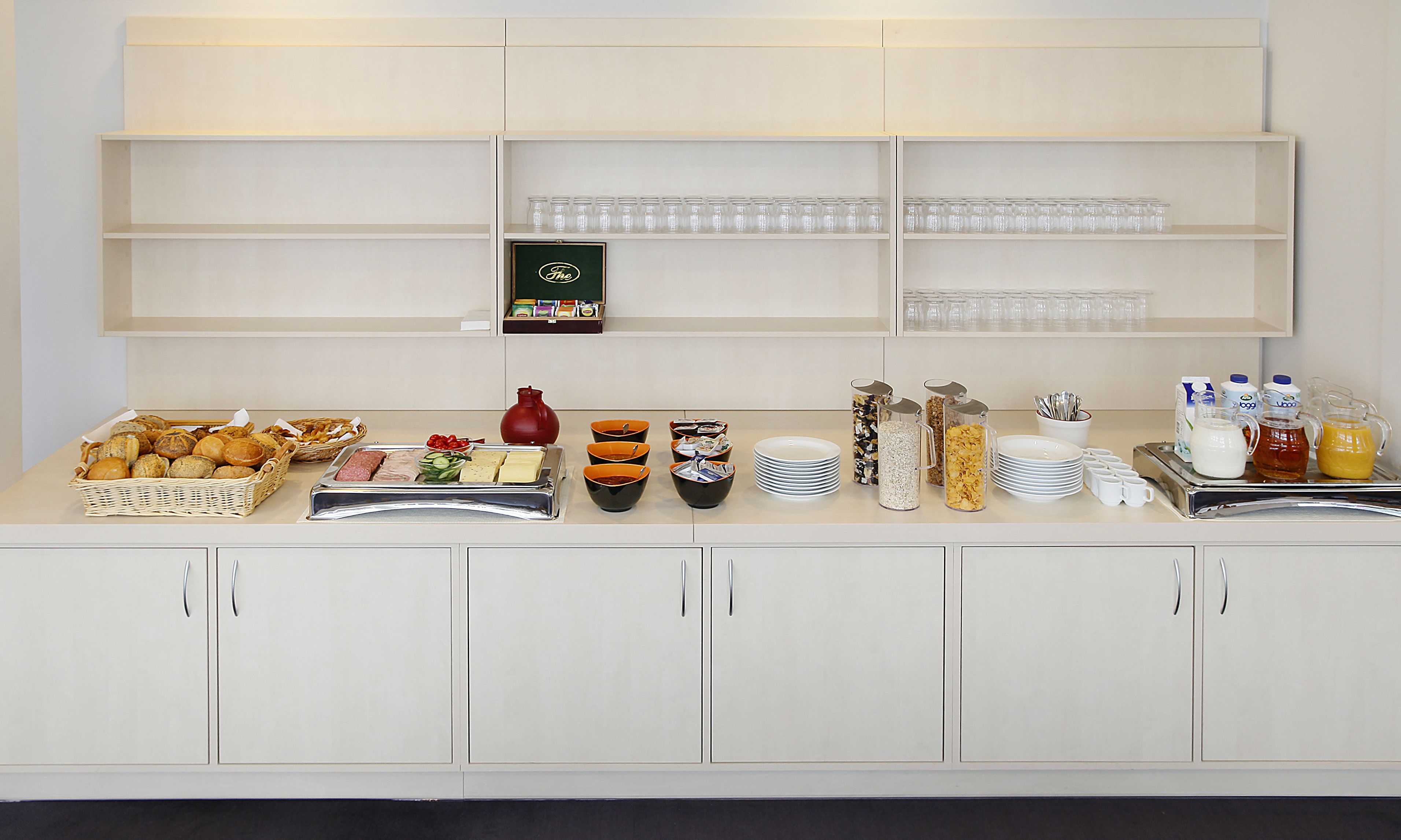 A buffet setup with various food items and beverages.