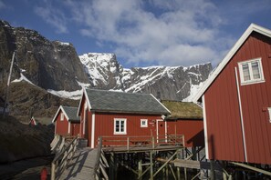 Coastal lodgings with simple, functional architecture, situated near a rocky shoreline.