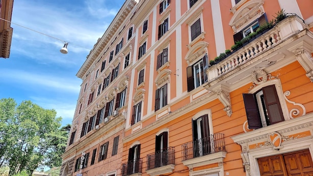 A multi-story building with ornate architectural details, including balconies and decorative moldings. - Dandi Domus (Rome)
