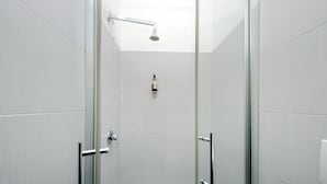 A modern shower with a glass door, a handheld showerhead, and a soap dispenser on the wall. - Dandi Domus (Rome)