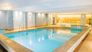 Relax by the rectangular pool surrounded by a tiled deck and mosaic walls.