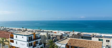 A coastal hotel with a view of the beach and ocean.