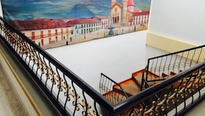A staircase with ornate black railings leading to a lower level. - Hotel Bolivar Plaza Manizales (Manizales)