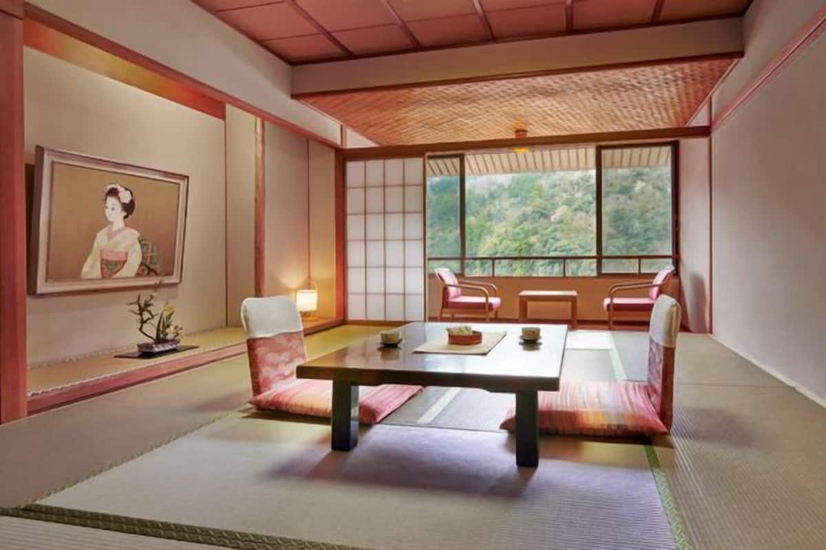 Een traditionele Japanse kamer met tatami vloerbedekking, een lage tafel en schuifdeuren.