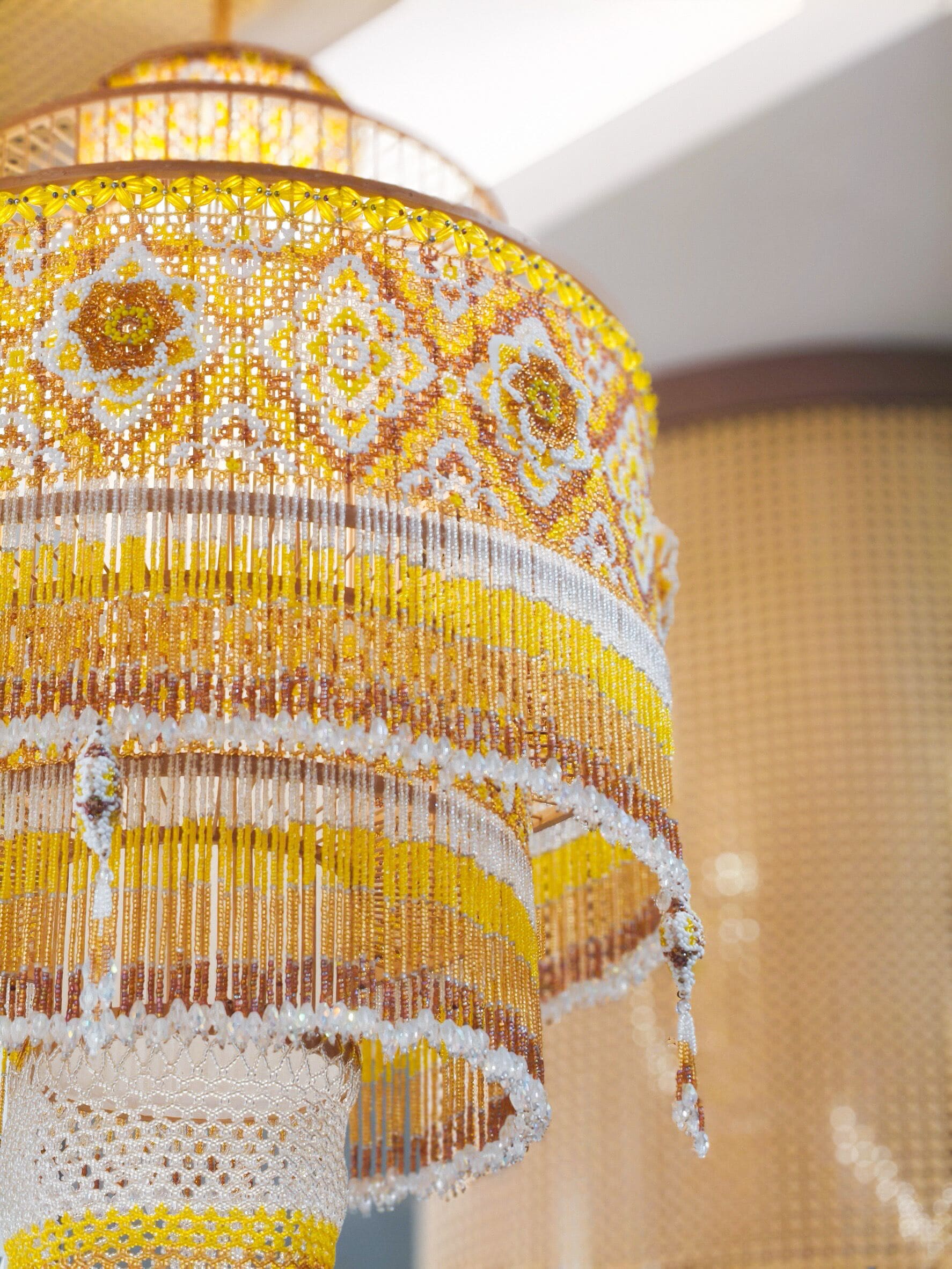 A close-up of a chandelier with intricate beadwork and a patterned design.